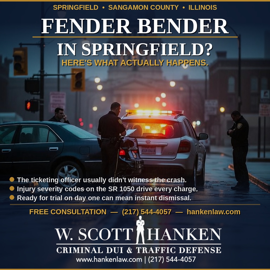 Springfield police officer investigating a fender bender accident scene at night — W. Scott Hanken defends traffic tickets in Sangamon County.