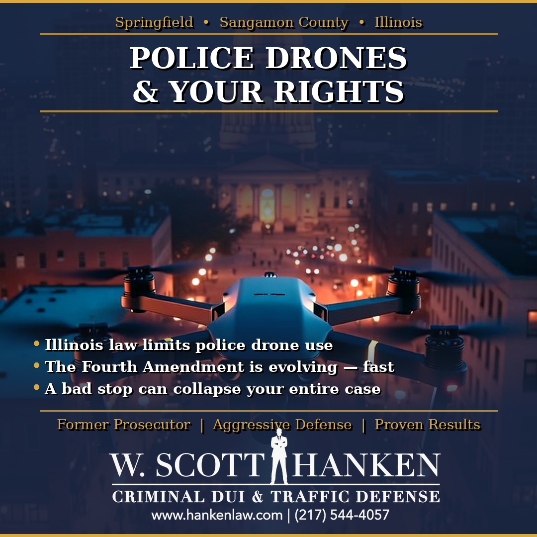 Police drone hovering over downtown Springfield, Illinois at night, illustrating a post on police drone surveillance Springfield IL rights by attorney W. Scott Hanken.